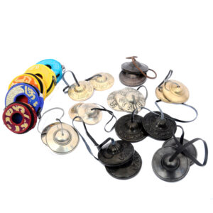 Collection of handmade Tibetan Tingsha bells with mantra embossing, dragon motifs, and eight auspicious symbols – perfect for meditation, yoga, and sound healing rituals