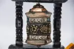 Tibetan prayer wheel with Ashtamangala embossing on copper and carved wood
