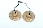 Austamangal Embossed Tibetan Chimes – affordable version crafted from mixed metal alloy with embossed Eight Auspicious Symbols, offering clear sound for beginners in meditation and spiritual practices.