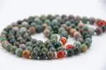 Bloodstone & Carnelian Mala – handcrafted 108-bead prayer necklace made from natural bloodstone and carnelian gemstones, known for boosting energy, courage, and grounding. Ideal for meditation, chakra healing, and spiritual strength.