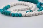 Conch Shell & Turquoise Prayer Beads – handcrafted 108-bead mala made from natural conch shell and turquoise stones, symbolizing purity, protection, and spiritual balance. Ideal for mantra chanting, meditation, and healing rituals.