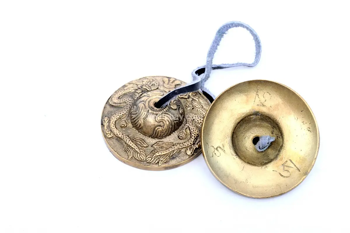 Dragon Embossed Tingsha Cymbals – handcrafted from a traditional 7-metal alloy with detailed dragon engravings, producing a clear, high-pitched tone ideal for meditation, energy clearing, and spiritual rituals.