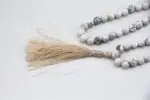 Howlite Stone Mala – handcrafted 108-bead prayer necklace made from natural howlite stones, known for calming the mind, easing stress, and promoting emotional healing. Ideal for meditation, mantra chanting, and mindfulness.