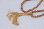 Raktu Seed Mala – handcrafted 108-bead prayer necklace made from natural raktu seeds, symbolizing protection, grounding, and spiritual focus. Ideal for meditation, mantra chanting, and daily spiritual practice