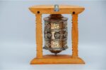 “8-inch wall hanging Tibetan prayer wheel with wooden frame and Austamangal symbol, handmade in Nepal”