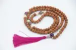 Rudraksha Mala with Pearl & Amethyst – handcrafted 108-bead prayer necklace combining sacred rudraksha seeds with calming pearl and spiritual amethyst, symbolizing protection, peace, and higher awareness. Ideal for meditation and spiritual growth.