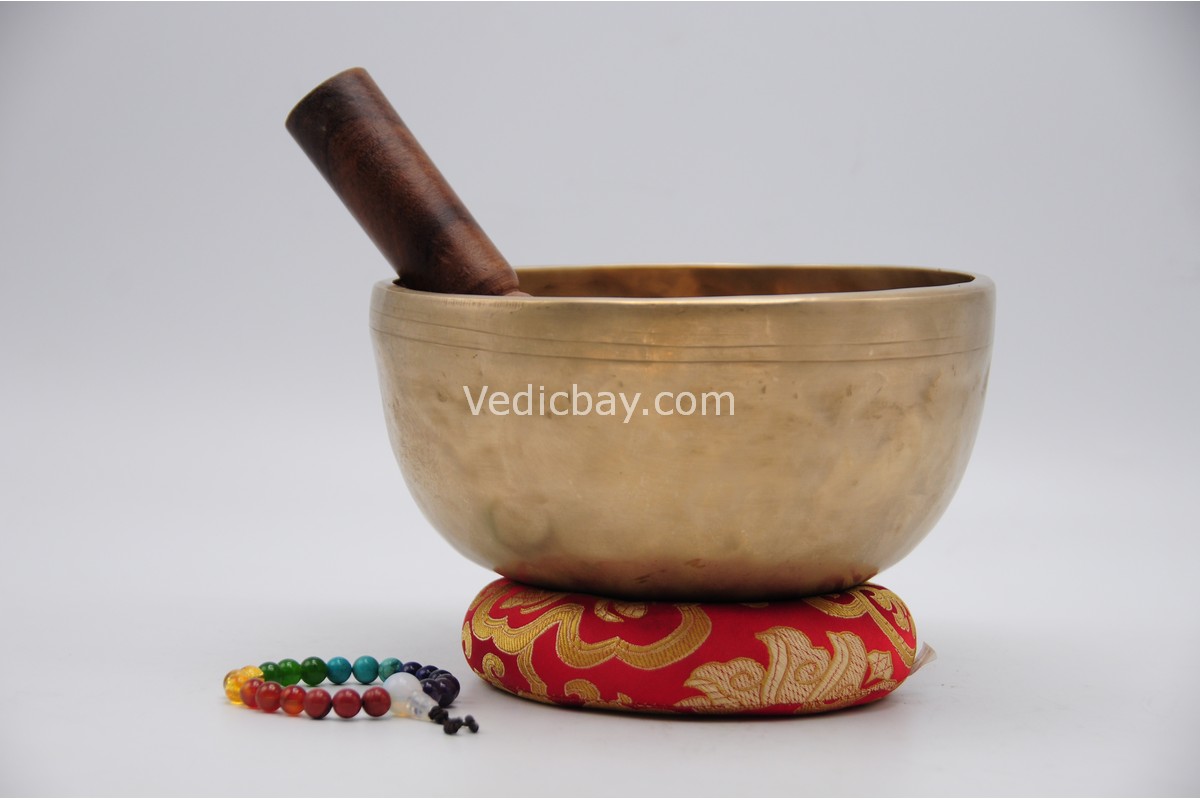 7 inch handmade Jhumka singing bowl crafted in Nepal with 7 chakra stone bracelet, mallet, and cushion