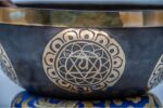 11-inch chakra Tibetan singing bowl carved with 7 chakra symbols – includes cushion, wooden mallet, felt striker, and bracelet – VedicBay