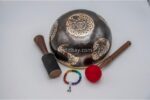 11-inch chakra Tibetan singing bowl carved with 7 chakra symbols – includes cushion, wooden mallet, felt striker, and bracelet – VedicBay