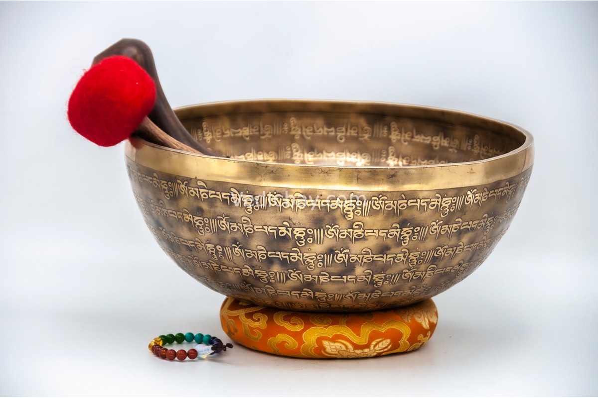 12-inch Tibetan singing bowl fully carved with mantras – includes cushion, wooden mallet, felt striker, and bracelet – VedicBay
